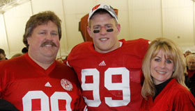 JJ Watt with his father, John, and mother, Connie, at the Wisconsin vs. Northwestern game in 2010