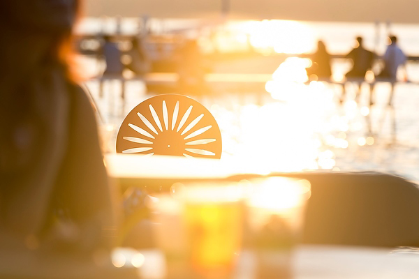 Photo of a sunsetting behind a Memorial Union Terrace Chair, photo by Jeff Miller | UW-Madison