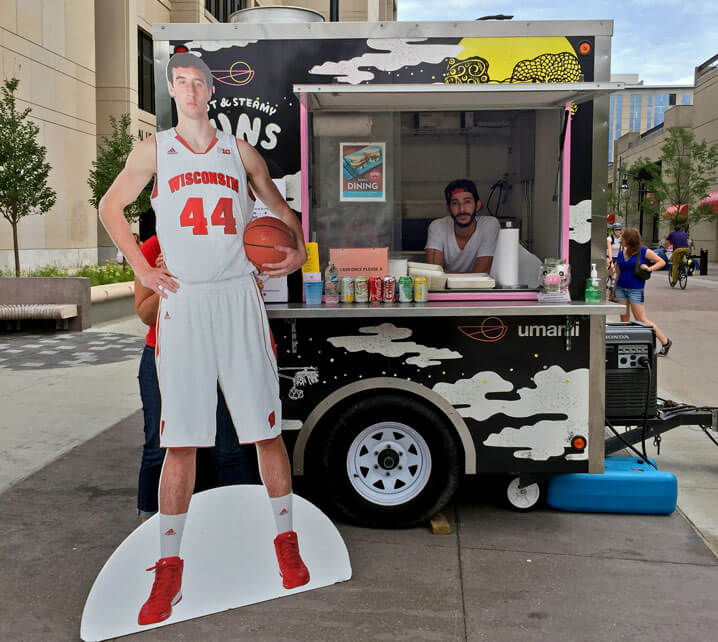 Cut-out of Frank Kaminsky at a food cart.