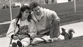 Photo from UW-Archives of a pair of students on Bascom, feeding a squirrel.