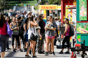 A crowd in front of food carts