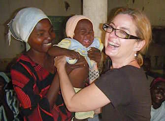 A woman interacting with a child and its mother