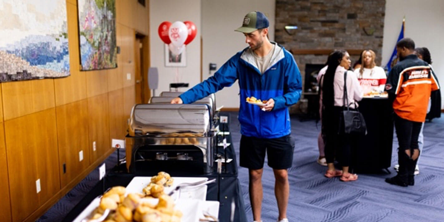 People in a buffet line. 