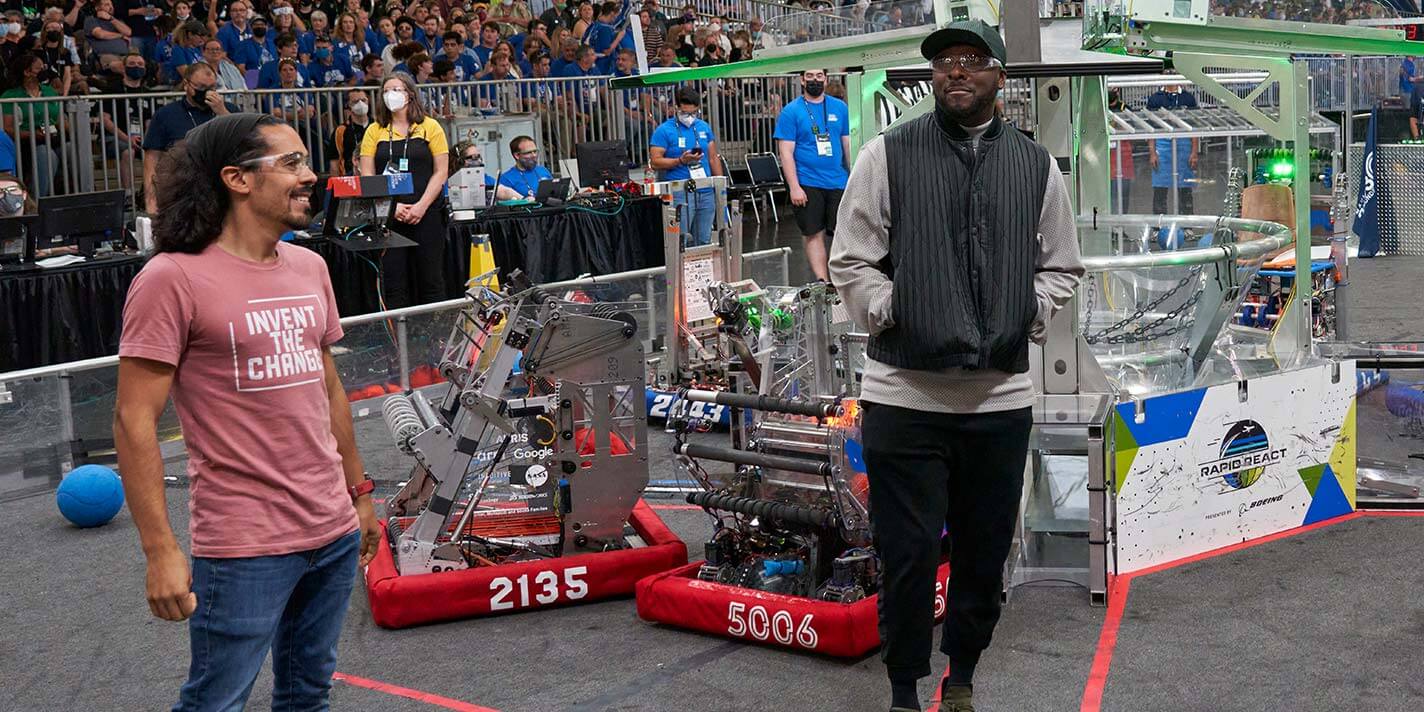 Jay Flores ’12 and rapper and STEM advocate will.i.am introduce teams during a match at the 2022 FIRST World Championship.
Credit: Dan Donovan
