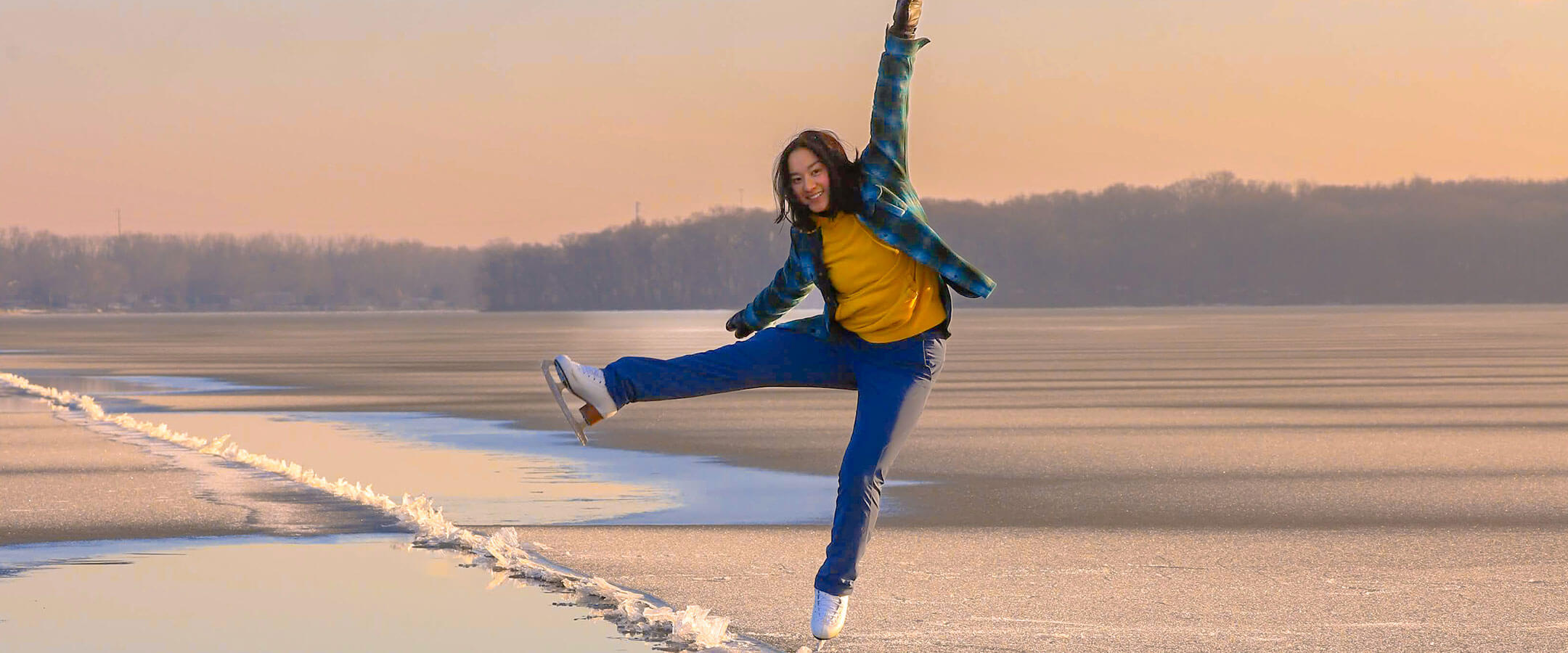 Angelina Huang skates on a frozen lake.