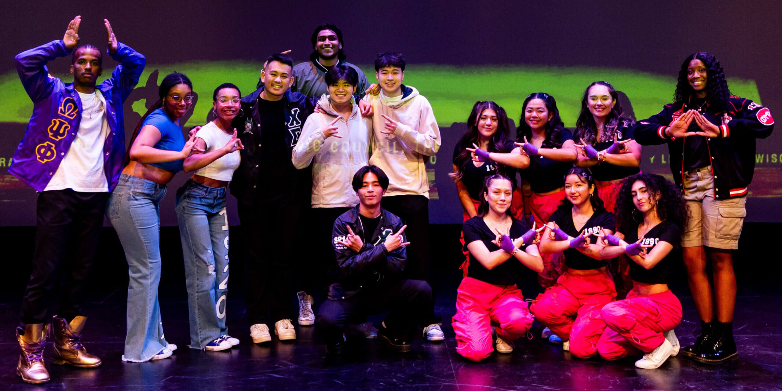 Winners of the 2023 Multicultural Homecoming Yard Show pose for a picture on stage.