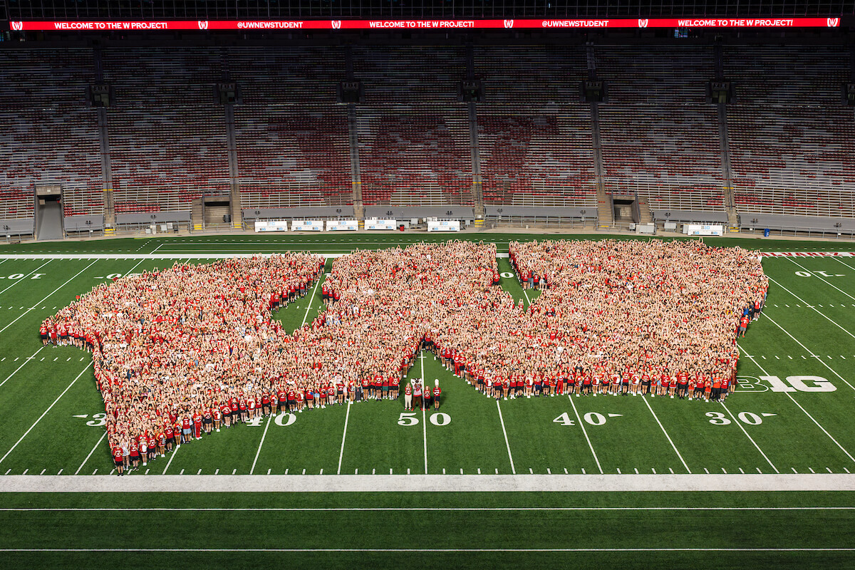 Students stand in a Motion W formation in Camp Randall.