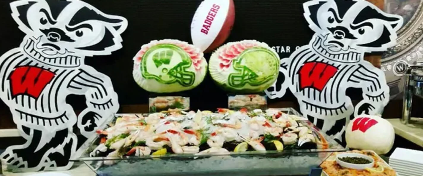 Two football helmets carved into two different watermelons.