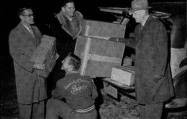 Many hands pitched in on the "Bucks for the Band" drive, and here WAA Executive Secretary John Berge '22 watched band members help with the mailing of 18,000 appeals for alumni support. All who did contribute to the fund received thank you cards from the Alumni Association.